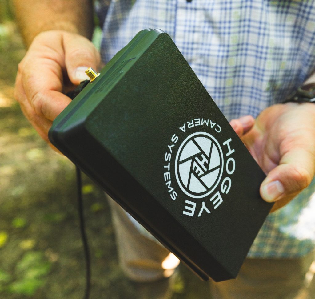 HogEye camera branding on a black device being held