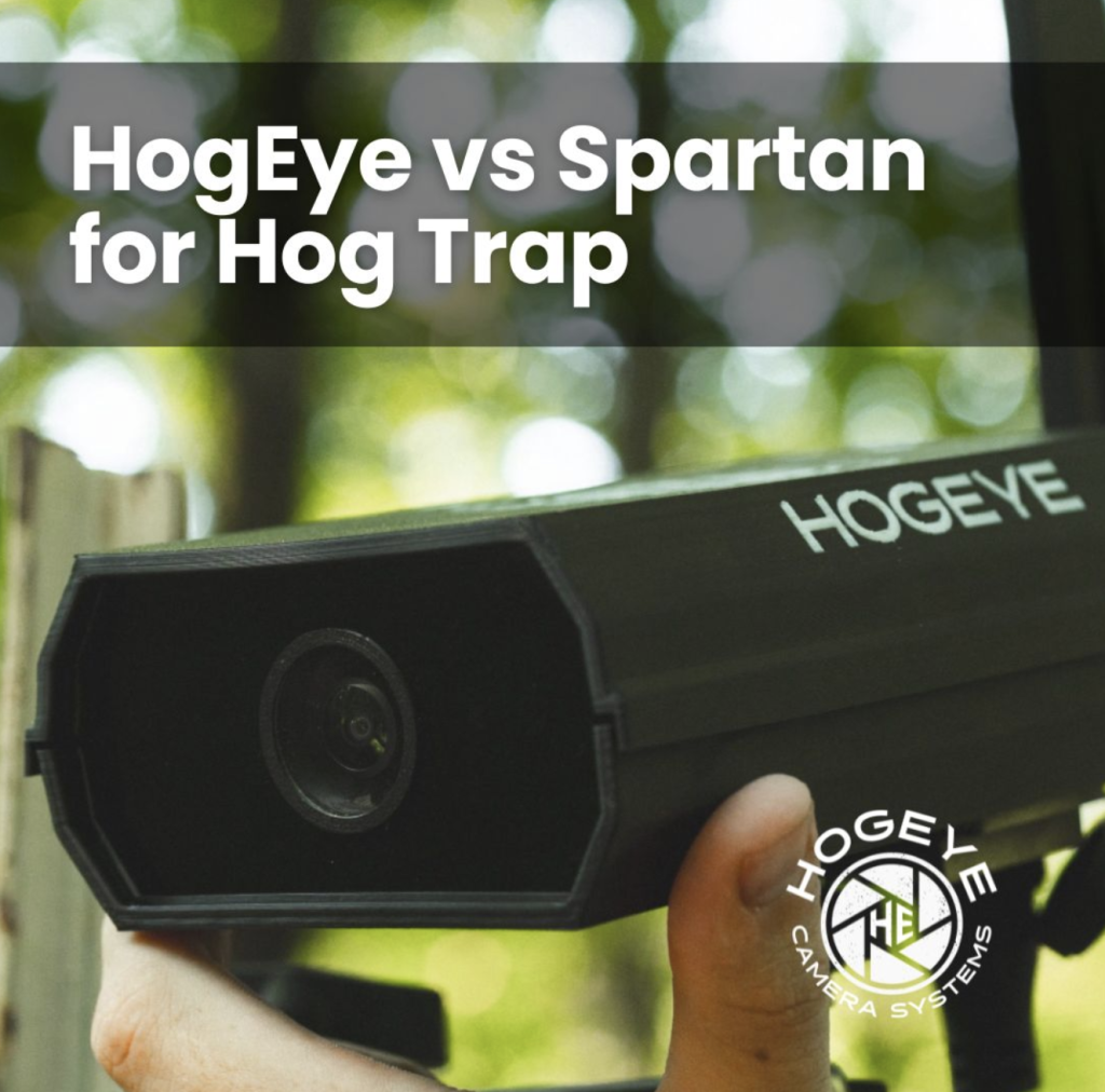 Handheld HogEye camera being held outdoors, with the 'HogEye vs Spartan for Hog Trap' banner across the top and a blurred green background.